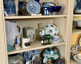 Beautifully curated shelves in den in the back of the house.