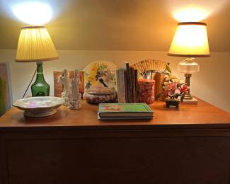 MCM chest in upstairs master. There is a matching long chest of drawers. Asian items are arranged on top, 