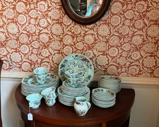 Several full sets of fine china. This is a game table. 