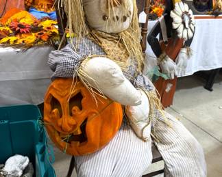 Stuffed scarecrow on antique chair