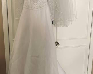 New with tags size six beaded wedding dress and veil