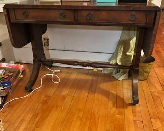 Looks like mahogany drop leaf front entry table or could be considered a two drawer writing desk. (Made by Baker Furniture.)