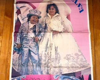 A poster showing Michu & Juliana as the shortest couple to ever have been married. NOTE the size of the poster to the dollar bill in the lower right corner. 