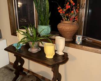 Side table, milking stool, Snake plant in McCoy jardiniere, Birds nest fern in McCoy planter, rattan basket, various planters