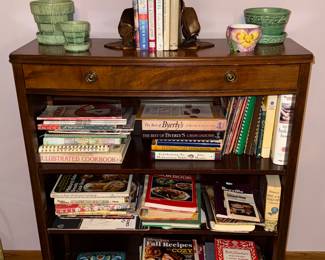 Wooden bookshelf with a drawer, McCoy planters, cookbooks
