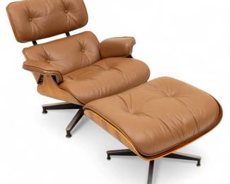 Lot 1056
Charles Eames for Herman Miller (American, 1907-1978) Walnut Veneer, Aluminum, and Leather Swivel Chair and Ottoman, 1970s, 2 PCS