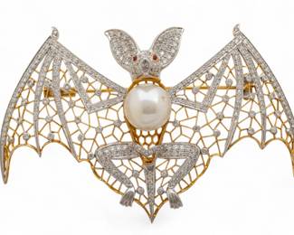 Lot 40
Diamond Pearl and 18 Kt. White and Yellow Gold 'Bat Form Brooch', H 2.5" L 3.5" 30 g 1 PC