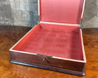 This lot features what appears to be a Victorian writing slope or lap desk. Locks and comes with the original skeleton key, with beautiful patina throughout. Please note, there is no "slope" and has a flat box surface inside. This stunning piece measures, 5” H x 14.5” W x 17.5” D.
