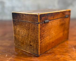 This lot features an antique English double tea caddy, likely Georgian and measures, 4.5” H x 7.25” W x 4.25” D. Tea caddies were popular in the 18th and 19th centuries when tea was a valuable commodity.
