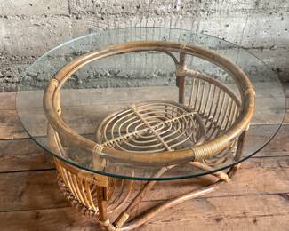 This lot features a vintage bamboo and rattan coffee table with a glass top, circa 1970s. In good overall condition and measures, 15” H x 30” W x 30” D.
