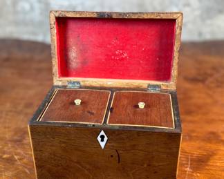This lot features an antique English double tea caddy, likely Georgian and measures, 4.5” H x 7.25” W x 4.25” D. Tea caddies were popular in the 18th and 19th centuries when tea was a valuable commodity.
