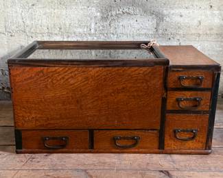 This lot features a Japanese hibachi cabinet with five (5) drawers, and a removable glass lid above the copper lined well. This cabinet measures, 14” H x 28” W x 15” D.
