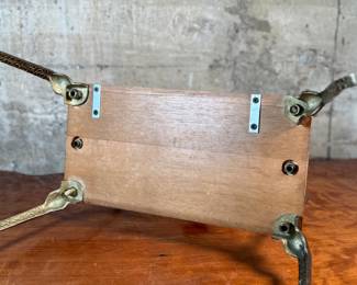 This lot features an Art Nouveau brass and wood magazine rack circa 1930s that measures, 18.5” H x 20.5” W x 12.5” D.
