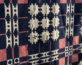 This lot features an incredible 19th century Welsh double-cloth "tapestry" blanket, with the iconic Caernarfon pattern. This design is one of the most recognizable traditional Welsh patterns, dating back to the early 19th century. This item can be used as a rug, blanket, hung as a work of art, or however you’d like to display and use it. Minor holes throughout, but in good overall condition for its age. This piece measures, 84” H x 74” W.
