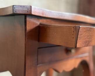 This lot features a Louis XV-style carved wooden nightstand with two drawers and cabriole legs in very good condition. This nightstand measures, 27.5” H x 17.5” W x 12.5” D.
