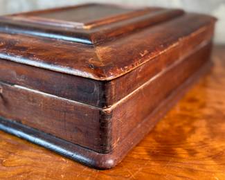 This lot features what appears to be a Victorian writing slope or lap desk. Locks and comes with the original skeleton key, with beautiful patina throughout. Please note, there is no "slope" and has a flat box surface inside. This stunning piece measures, 5” H x 14.5” W x 17.5” D.
