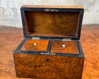 This lot features an antique English double tea caddy, likely Georgian and measures, 5.5” H x 9” W x 5” D. Tea caddies were popular in the 18th and 19th centuries when tea was a valuable commodity.
