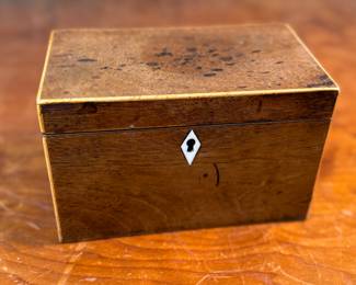 This lot features an antique English double tea caddy, likely Georgian and measures, 4.5” H x 7.25” W x 4.25” D. Tea caddies were popular in the 18th and 19th centuries when tea was a valuable commodity.
