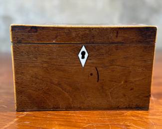 This lot features an antique English double tea caddy, likely Georgian and measures, 4.5” H x 7.25” W x 4.25” D. Tea caddies were popular in the 18th and 19th centuries when tea was a valuable commodity.
