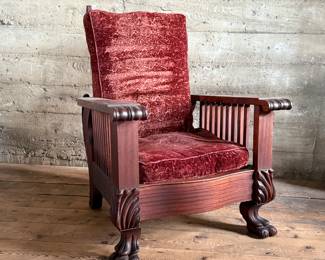 This lot features a stunning antique Morris chair with an adjustable back, removable cushions, and a spindle design on the sides with carved paw feet. This chair measures, 39” H x 31” W x 30.5” D.
