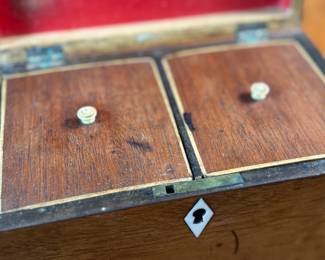 This lot features an antique English double tea caddy, likely Georgian and measures, 4.5” H x 7.25” W x 4.25” D. Tea caddies were popular in the 18th and 19th centuries when tea was a valuable commodity.
