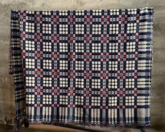 This lot features an incredible 19th century Welsh double-cloth "tapestry" blanket, with the iconic Caernarfon pattern. This design is one of the most recognizable traditional Welsh patterns, dating back to the early 19th century. This item can be used as a rug, blanket, hung as a work of art, or however you’d like to display and use it. Minor holes throughout, but in good overall condition for its age. This piece measures, 84” H x 74” W.
