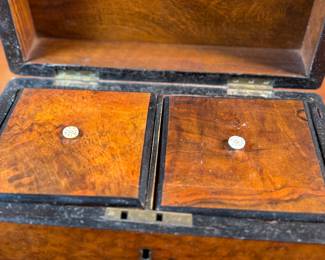 This lot features an antique English double tea caddy, likely Georgian and measures, 5.5” H x 9” W x 5” D. Tea caddies were popular in the 18th and 19th centuries when tea was a valuable commodity.
