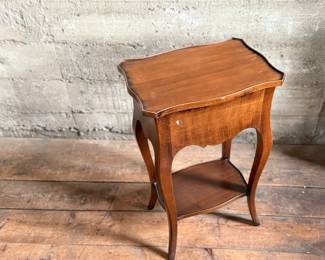 This lot features a Louis XV-style carved wooden nightstand with two drawers and cabriole legs in very good condition. This nightstand measures, 27.5” H x 17.5” W x 12.5” D.
