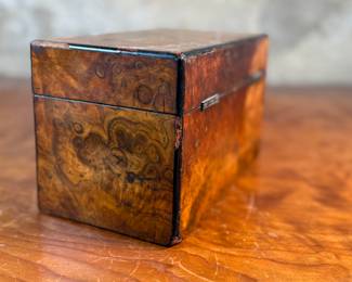 This lot features an antique English double tea caddy, likely Georgian and measures, 5.5” H x 9” W x 5” D. Tea caddies were popular in the 18th and 19th centuries when tea was a valuable commodity.
