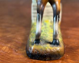 This lot features a sculpture of a jockey on a horse jumping over a fence, manufactured by ABCO, otherwise known as the Alexander Backer Company. In good overall condition with minor wear shown in photos, original ABCO sticker underneath, and measures, 9” H x 11” W x 3.5” D.
