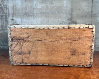 This lot features an antique trunk, most likely an immigrant trunk circa 1890s. The trunk is made of wood and animal hide with a lined paper interior. This trunk measures, 8” H x 21” W x 10.5” D.
