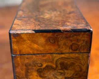 This lot features an antique English double tea caddy, likely Georgian and measures, 5.5” H x 9” W x 5” D. Tea caddies were popular in the 18th and 19th centuries when tea was a valuable commodity.
