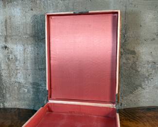 This lot features what appears to be a Victorian writing slope or lap desk. Locks and comes with the original skeleton key, with beautiful patina throughout. Please note, there is no "slope" and has a flat box surface inside. This stunning piece measures, 5” H x 14.5” W x 17.5” D.
