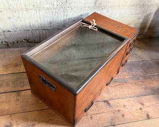 This lot features a Japanese hibachi cabinet with five (5) drawers, and a removable glass lid above the copper lined well. This cabinet measures, 14” H x 28” W x 15” D.
