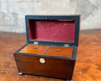 This lot features an antique English double tea caddy, likely Georgian and measures, 5.5” H x 8” H x 4.25” D. Tea caddies were popular in the 18th and 19th centuries when tea was a valuable commodity.

