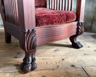 This lot features a stunning antique Morris chair with an adjustable back, removable cushions, and a spindle design on the sides with carved paw feet. This chair measures, 39” H x 31” W x 30.5” D.
