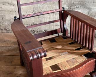 This lot features a stunning antique Morris chair with an adjustable back, removable cushions, and a spindle design on the sides with carved paw feet. This chair measures, 39” H x 31” W x 30.5” D.
