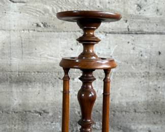 This lot features a Victorian carved mahogany torchere in excellent condition and measures, 37.25” H x 10” W x 10” D.
