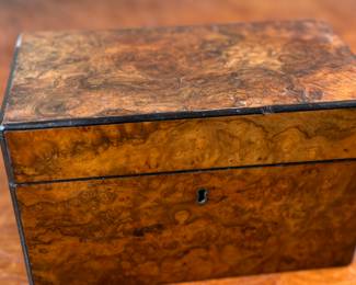 This lot features an antique English double tea caddy, likely Georgian and measures, 5.5” H x 9” W x 5” D. Tea caddies were popular in the 18th and 19th centuries when tea was a valuable commodity.
