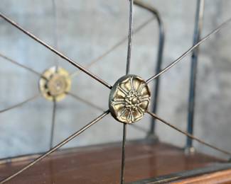 This lot features an Art Nouveau brass and wood magazine rack circa 1930s that measures, 18.5” H x 20.5” W x 12.5” D.
