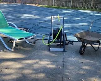 lounge chair, hose reel, wheelbarrow