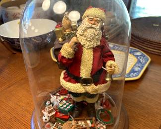 vintage Santa Claus figurine in a glass dome.