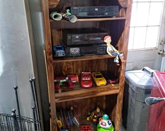 One of two open cabinets and older toys