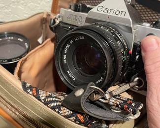 SEVERAL VINTAGE CAMERA'S AND PHOTO EQUIPMENT   THIS ONE CANON AE-1 W/ 3 LENSES AND CASE  