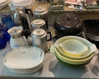 Several vintage coffee percolators, ready to use. Check out the Pyrex bowls 