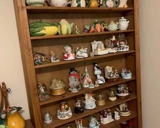 Collection of veggie shaped soup bowls along with teapots. Also, a large collection of music boxes. 
