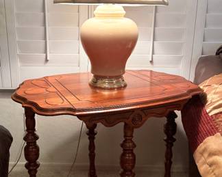 Wood side table with carved designs