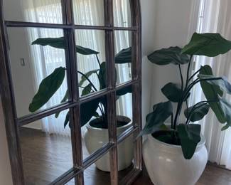 Large standing arched window style mirror. Faux Plant