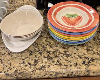 More white serving dishes and colorful plates