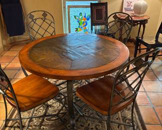 Beautiful slate top dining table, four  heavy matching dining chairs, decorative rug, antique side table, ladder, lamp, and pictures